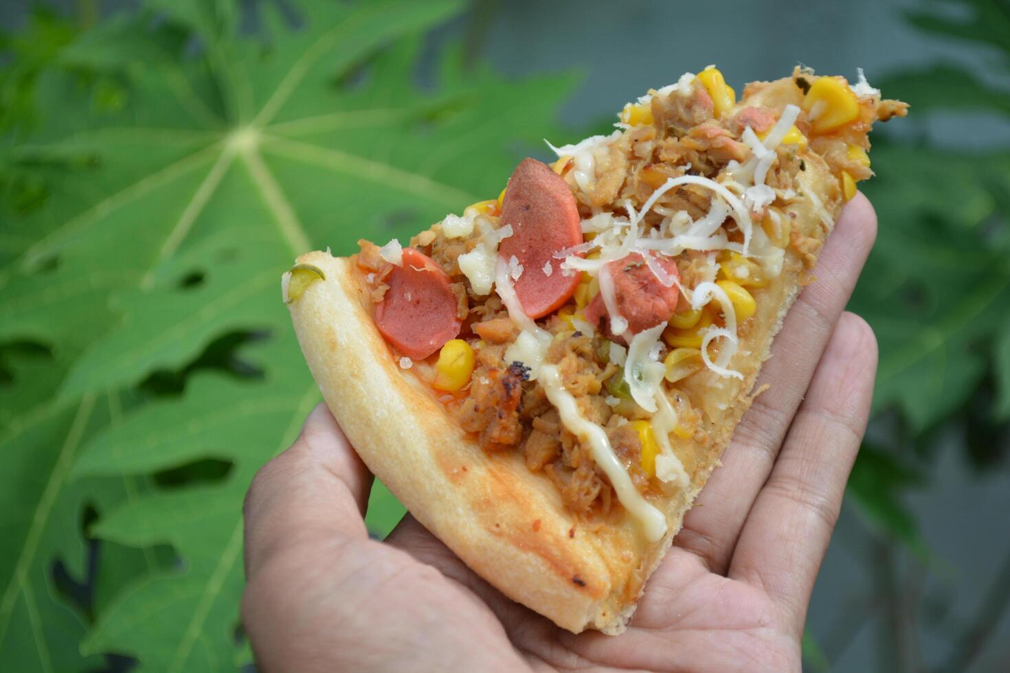 Delicious pizza with topping sausages, cheese, and corn, delicious meal to eat photo