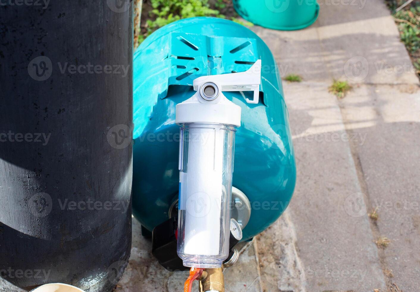 The system of modern water supply in a country house from a well source. Hydraulic accumulator for filling with water, sand filtration with filters. Industri photo