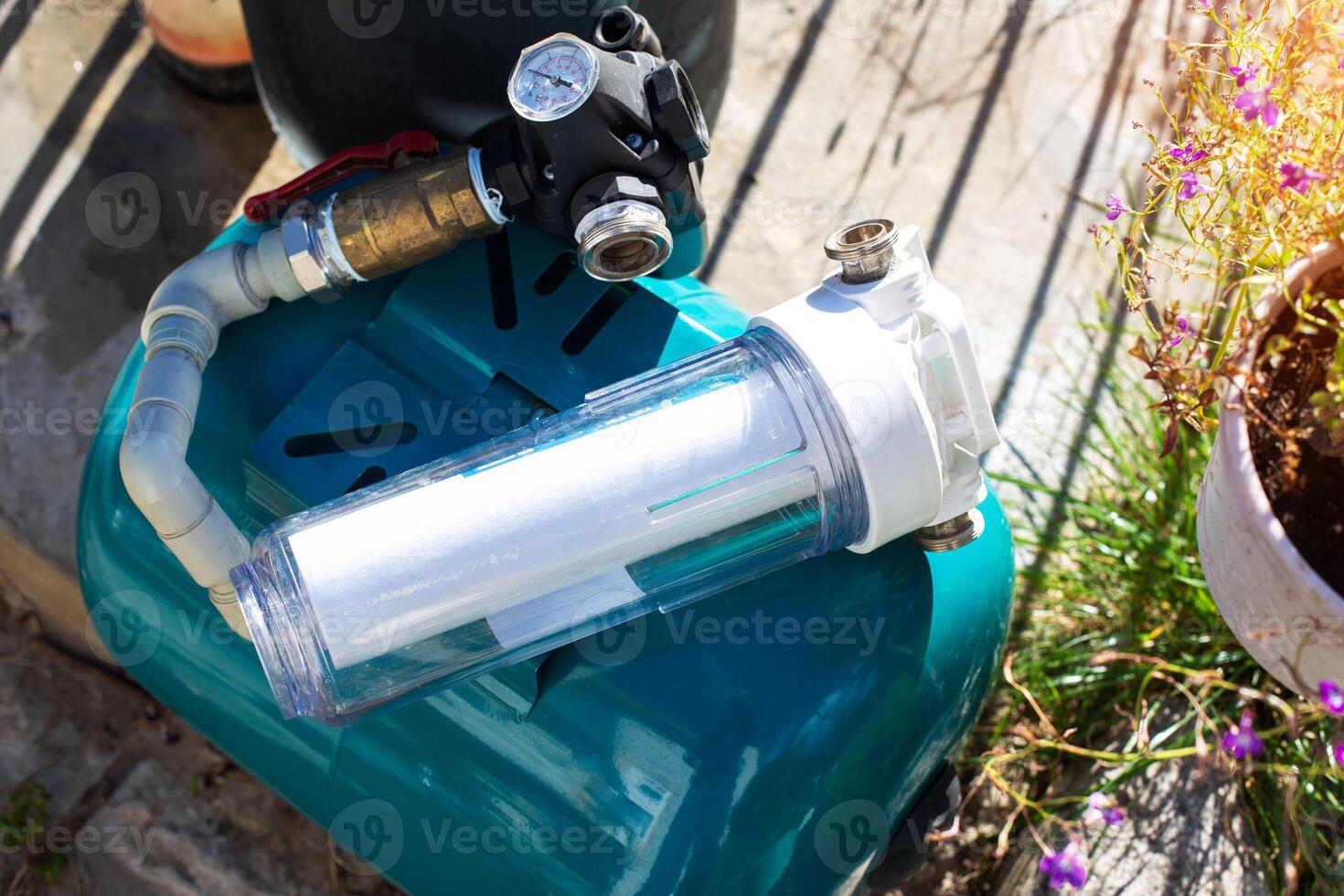 Water supply system with a hydraulic tank and a cleaning filter from a well in the country. photo