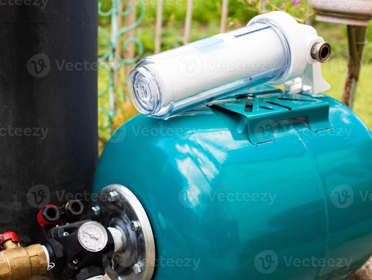 Filtration of water from a well with a sand and dirt filter. Water supply in the country. photo