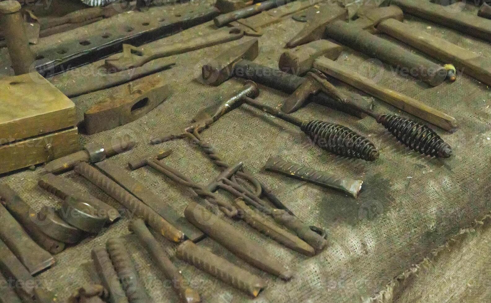 Lots of metal tools to work in the forge. Background, industry. photo