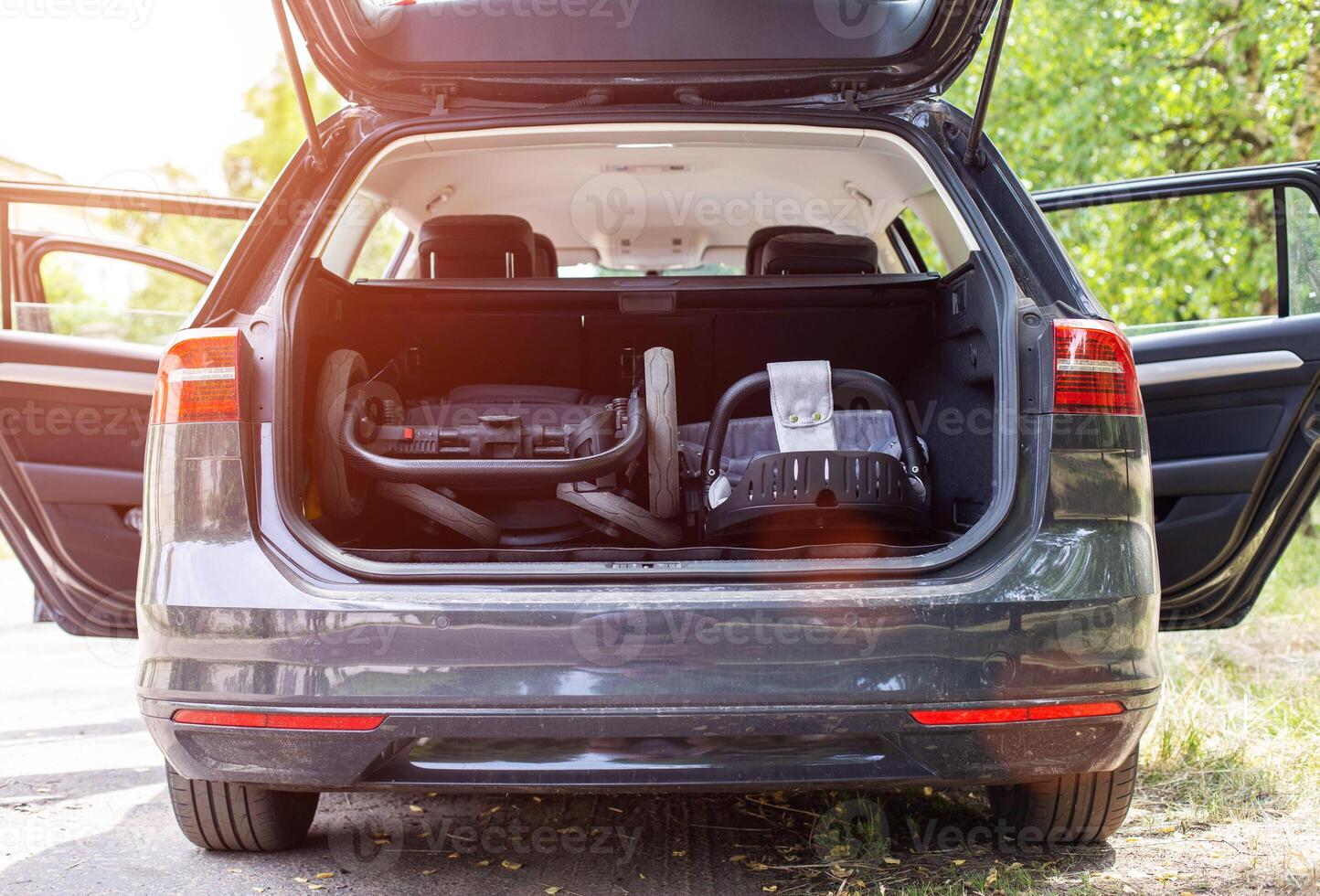 transporting a baby stroller in the trunk of a car when folded, close-up photo