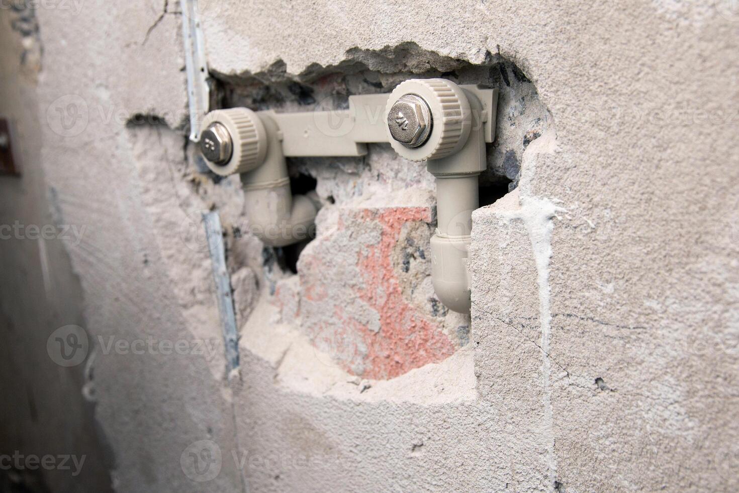 Water supply in polypropylene pipes in a concrete wall. Silencers. photo