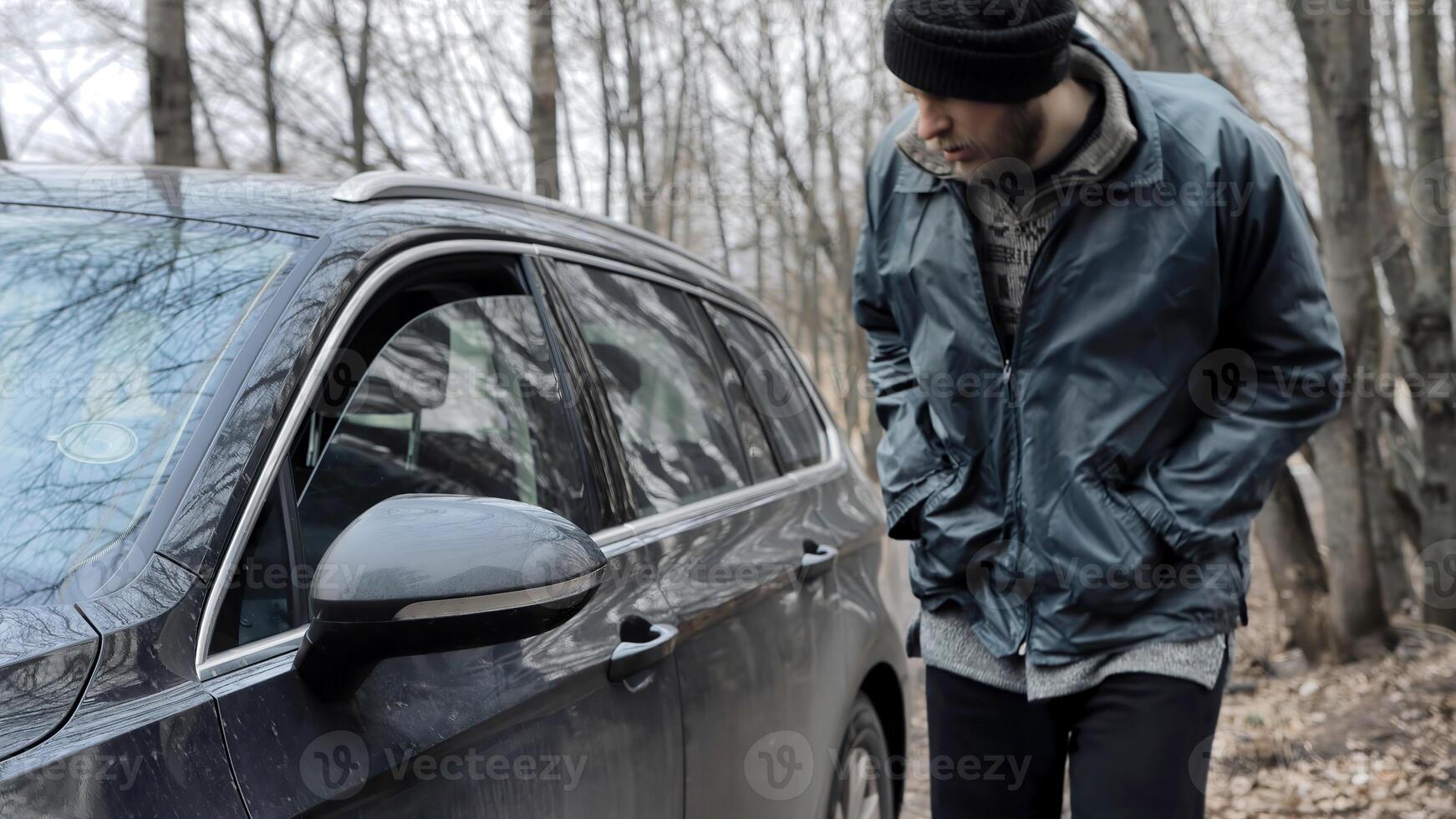Homeless man walks up to someone else's car, male burglar robber looks through the slightly open window of auto's door and walks away. Vehicle with alarm system. Property insurance against theft crime photo