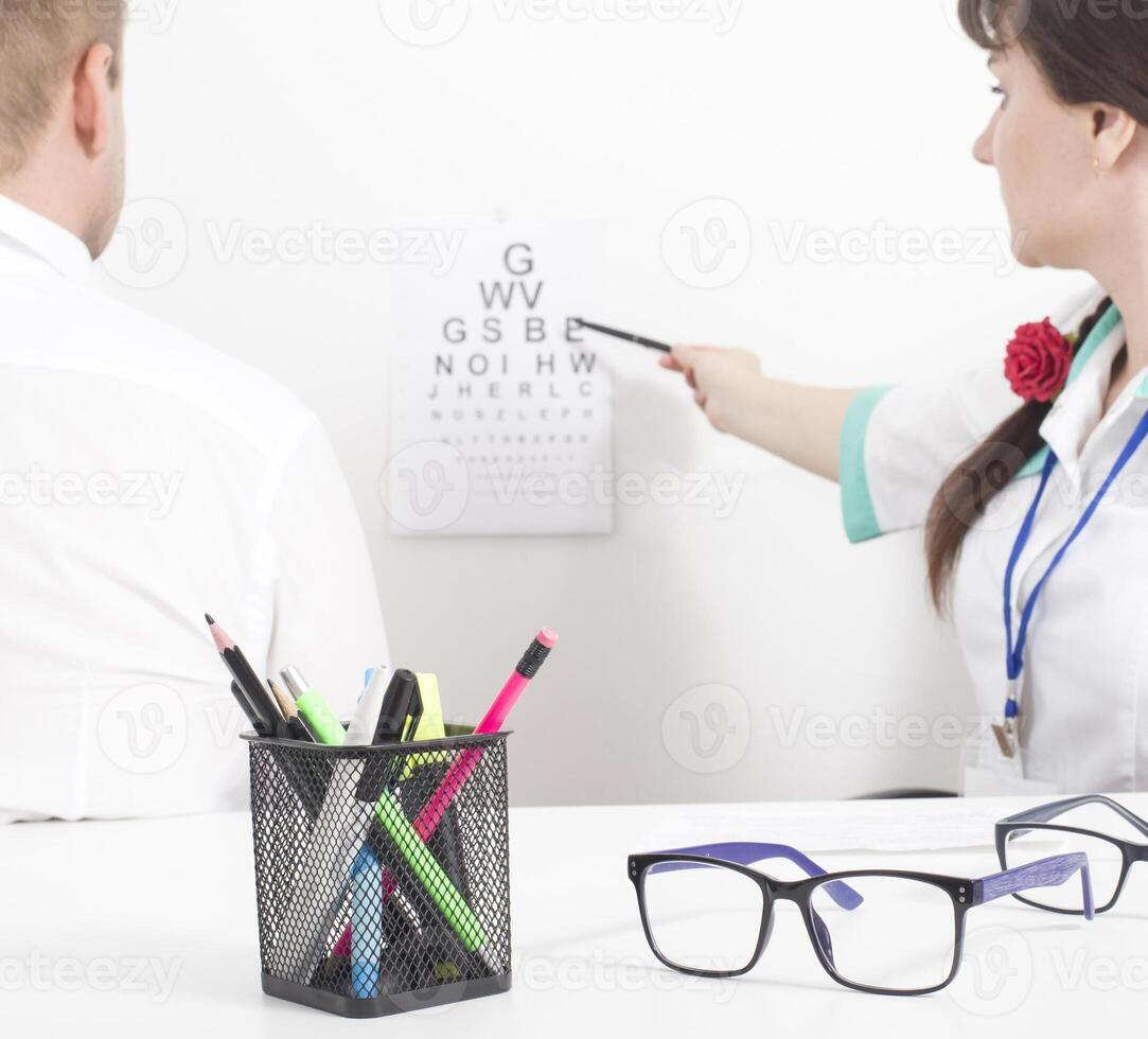 A patient is taken by an ophthalmologist who checks visual acuity. Ophthalmic diseases concept cataract and glaucoma, background photo
