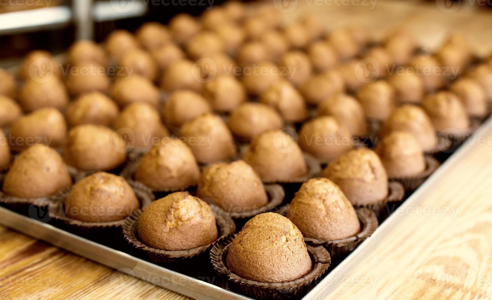 A tray of delicious fresh pastries made from muffins and muffins. lots of chocolate muffins, background, bakery products photo