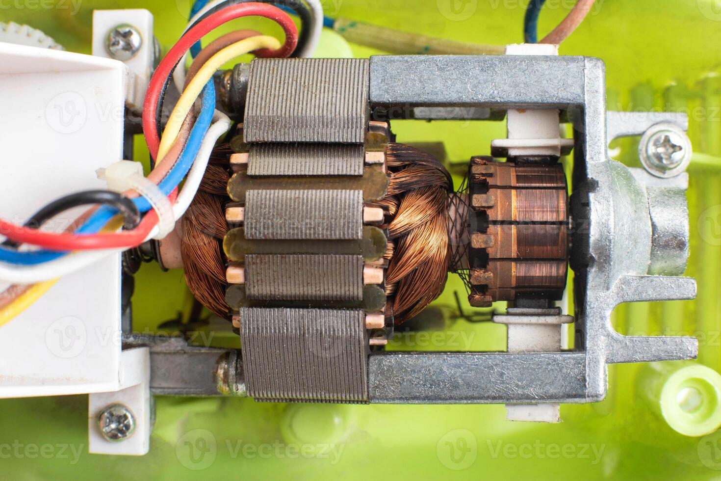 Broken electric motor in a household appliance hand mixer. Malfunction of the rotor and stator of electrical components, close-up photo