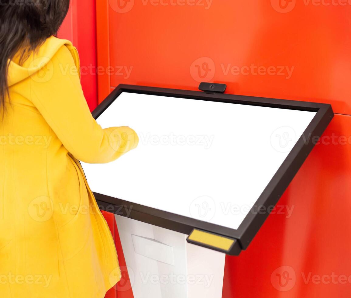 The girl clicks on the touch screen of the information assistant and help in the bank, copy space. Place for text. Modern technologies photo