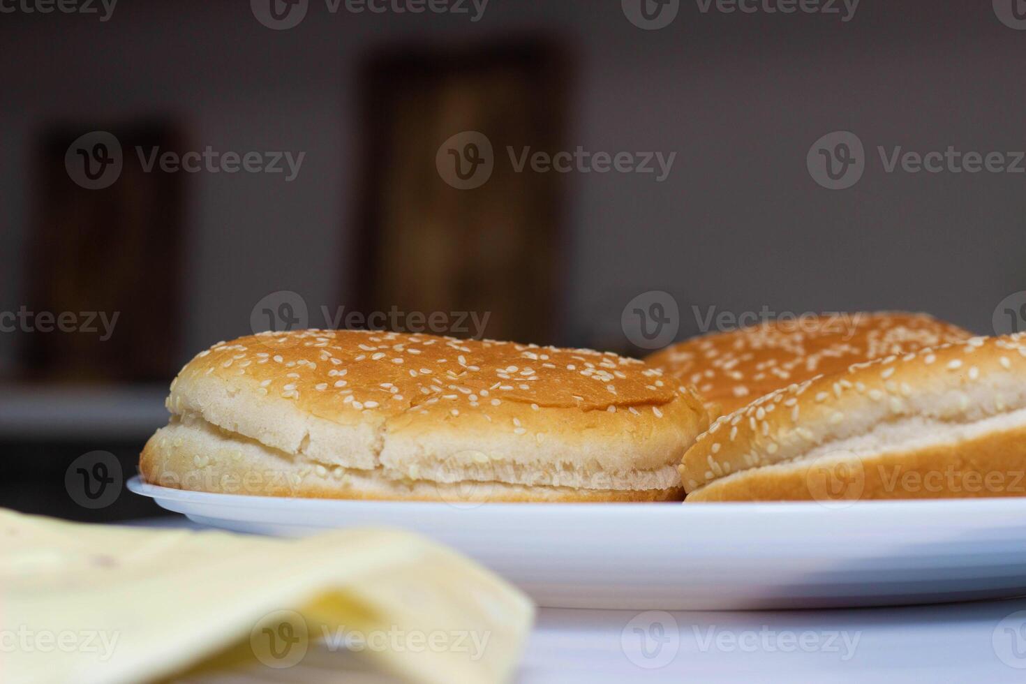 The ingredients are in the kitchen in the form of cheese, salad, tomato and burger rolls. Cooking Burgers at Home, Background photo