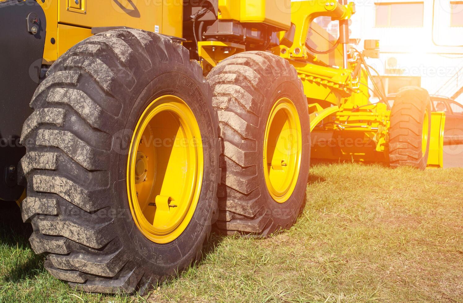 new modern grader for planning and moving soil. Road construction and leveling, industry photo