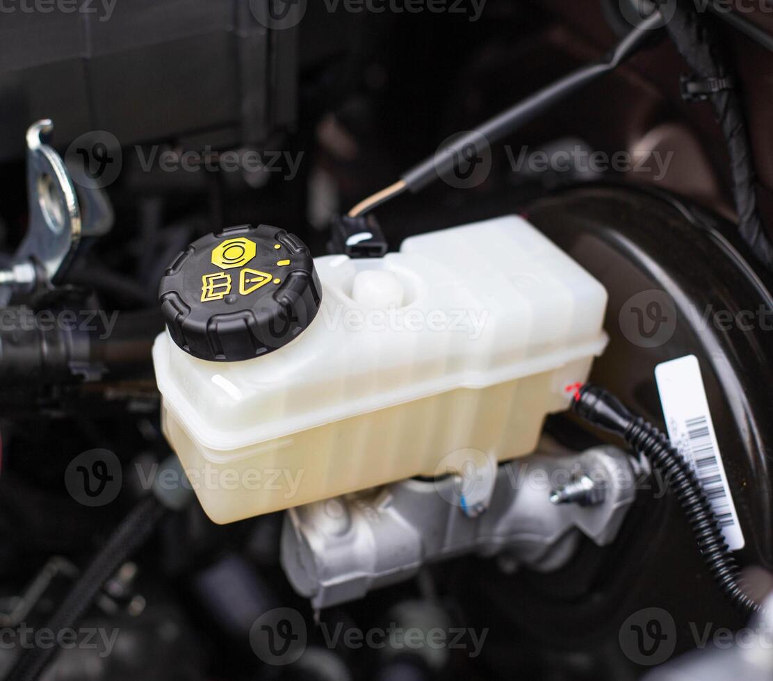 The tank with brake fluid in the car in the engine compartment. The concept of the working brake system, safety photo