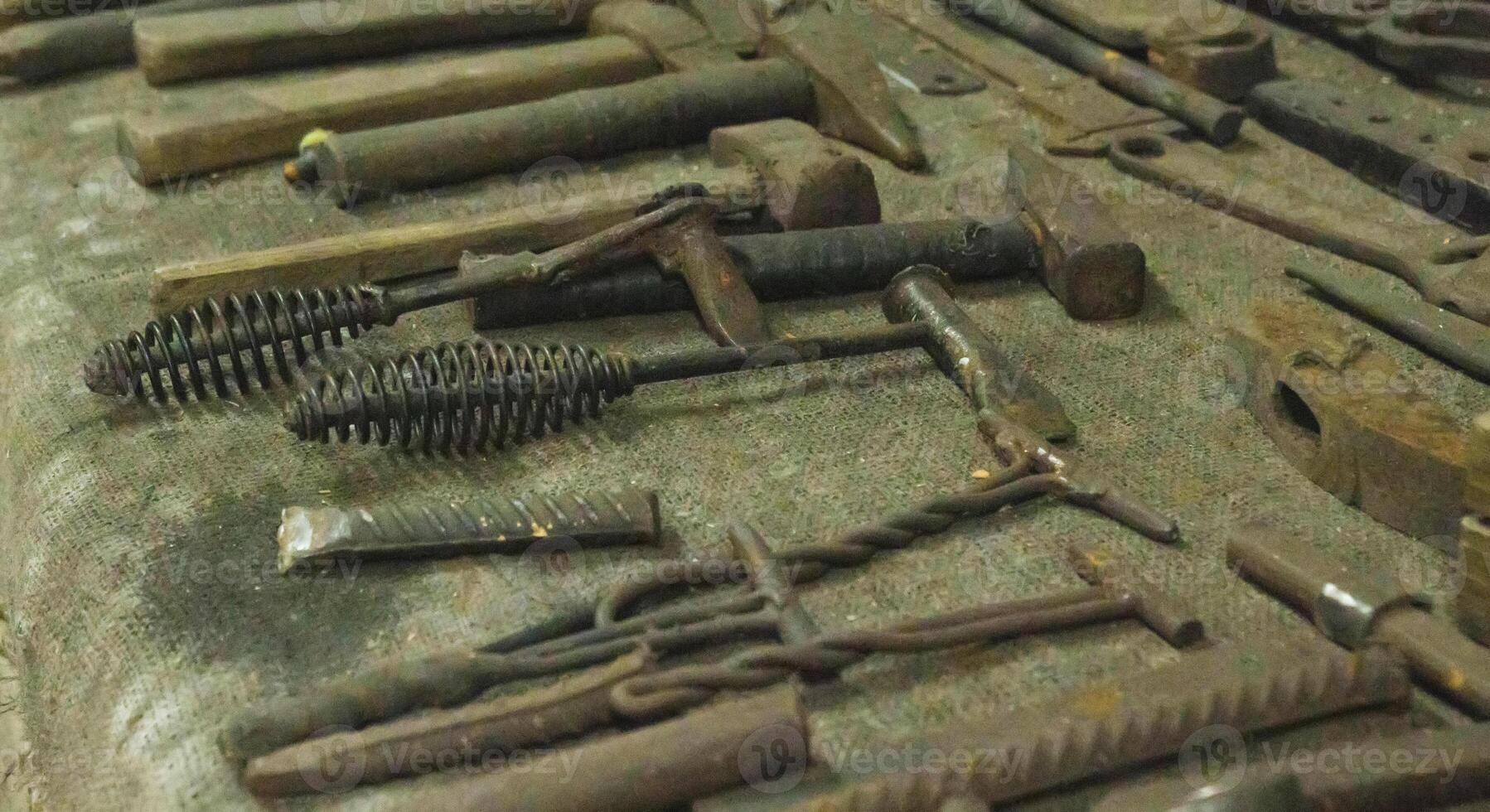 Lots of metal tools to work in the forge. Background, industry. photo