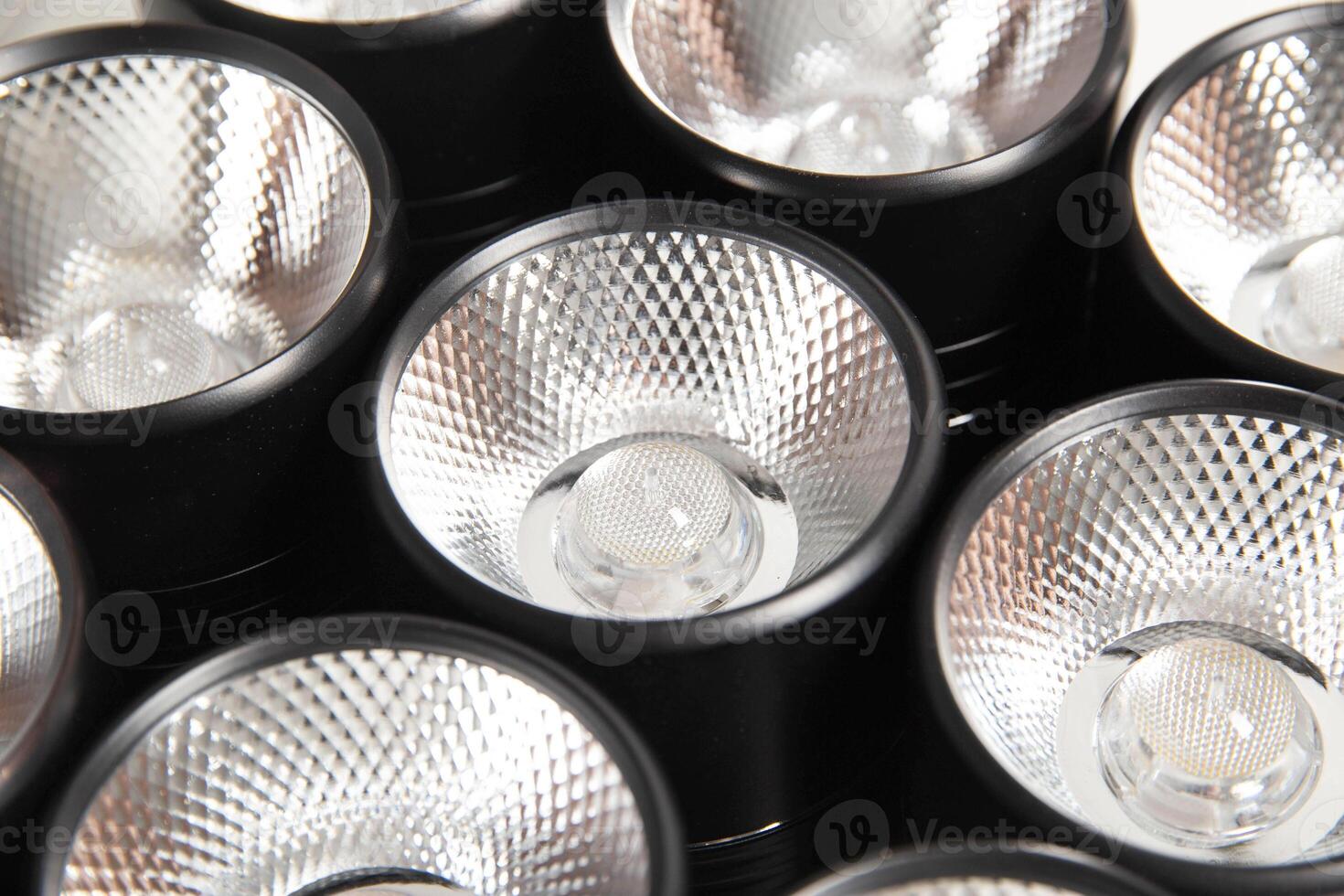 Spot overhead black lamps on a stretch ceiling on a white background. Lamps in the shape of a tube, close-up photo