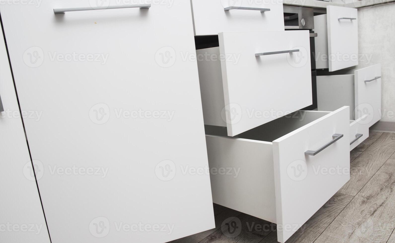 Organization of storage of utensils in the kitchen. Modern headset and planning for the manufacture of a section and drawers in the kitchen. Convenience of the location of dishes. photo