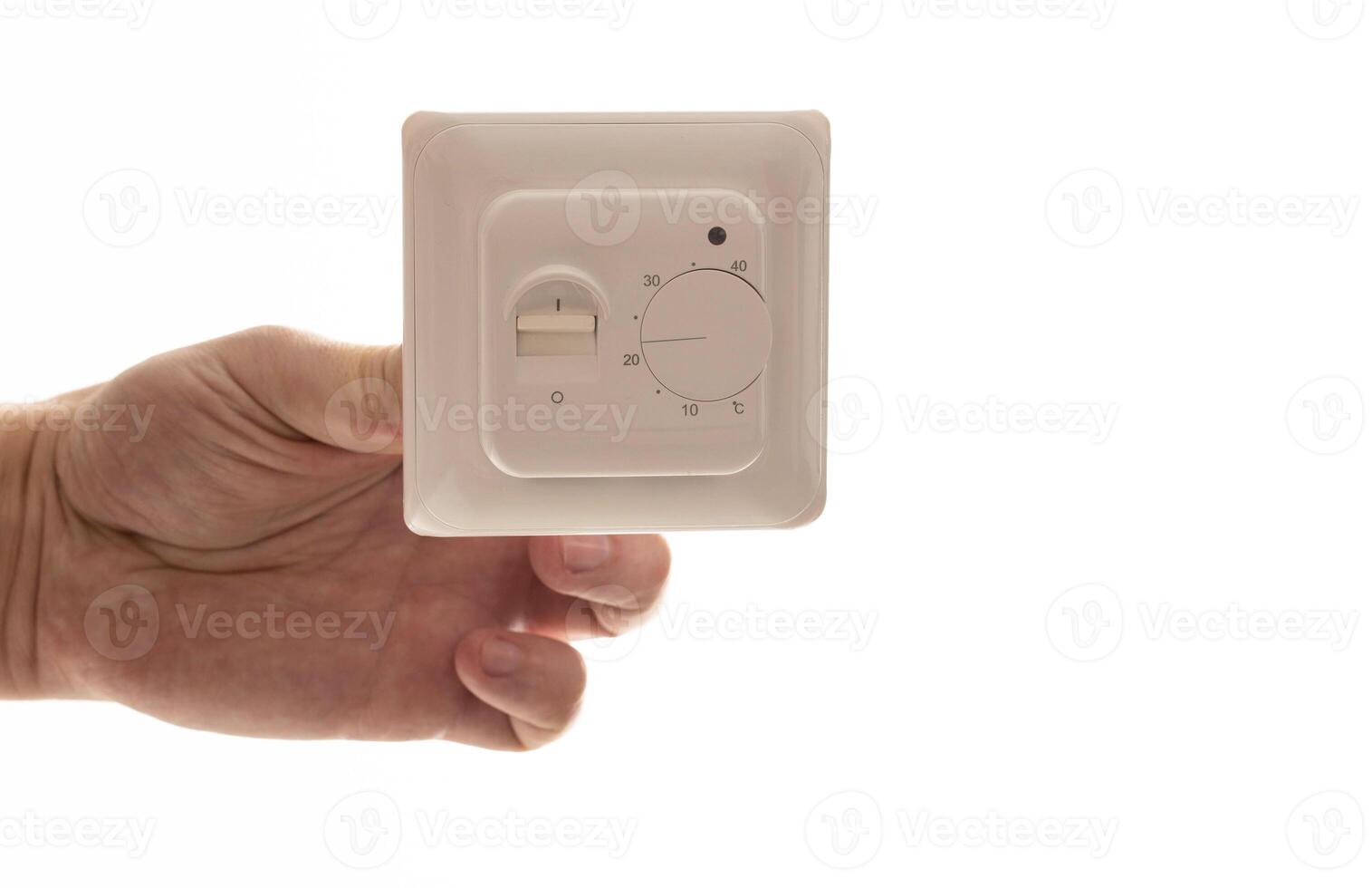 A man holds in his hand an electric thermostat for a warm floor on a white background, isolate. Close-up photo