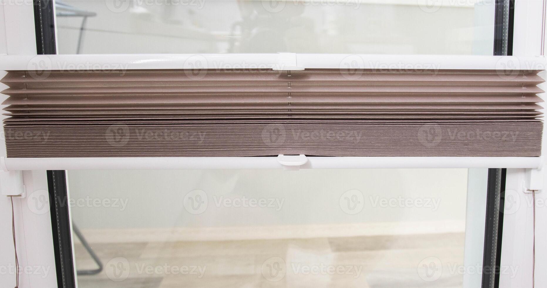 Modern classic aluminum blinds on the window sash with a scaffold fixing system. Protection from prying eyes and the sun. photo
