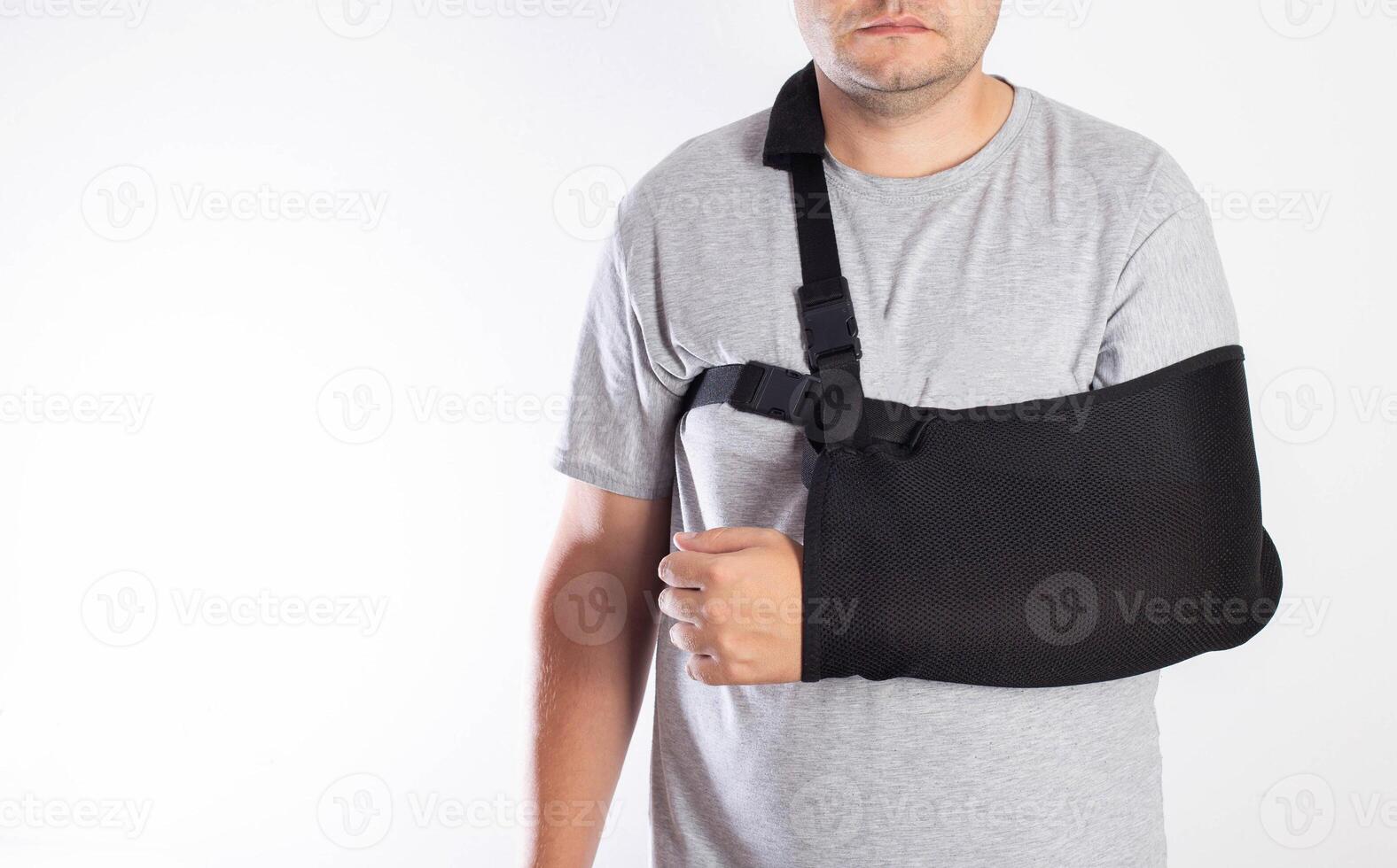 A man's arm in a black bandage for immobilization of the elbow joint after an injury. Bandage for rehabilitation after fractures of the humerus, ulna and radius. Sprain, traumatology photo