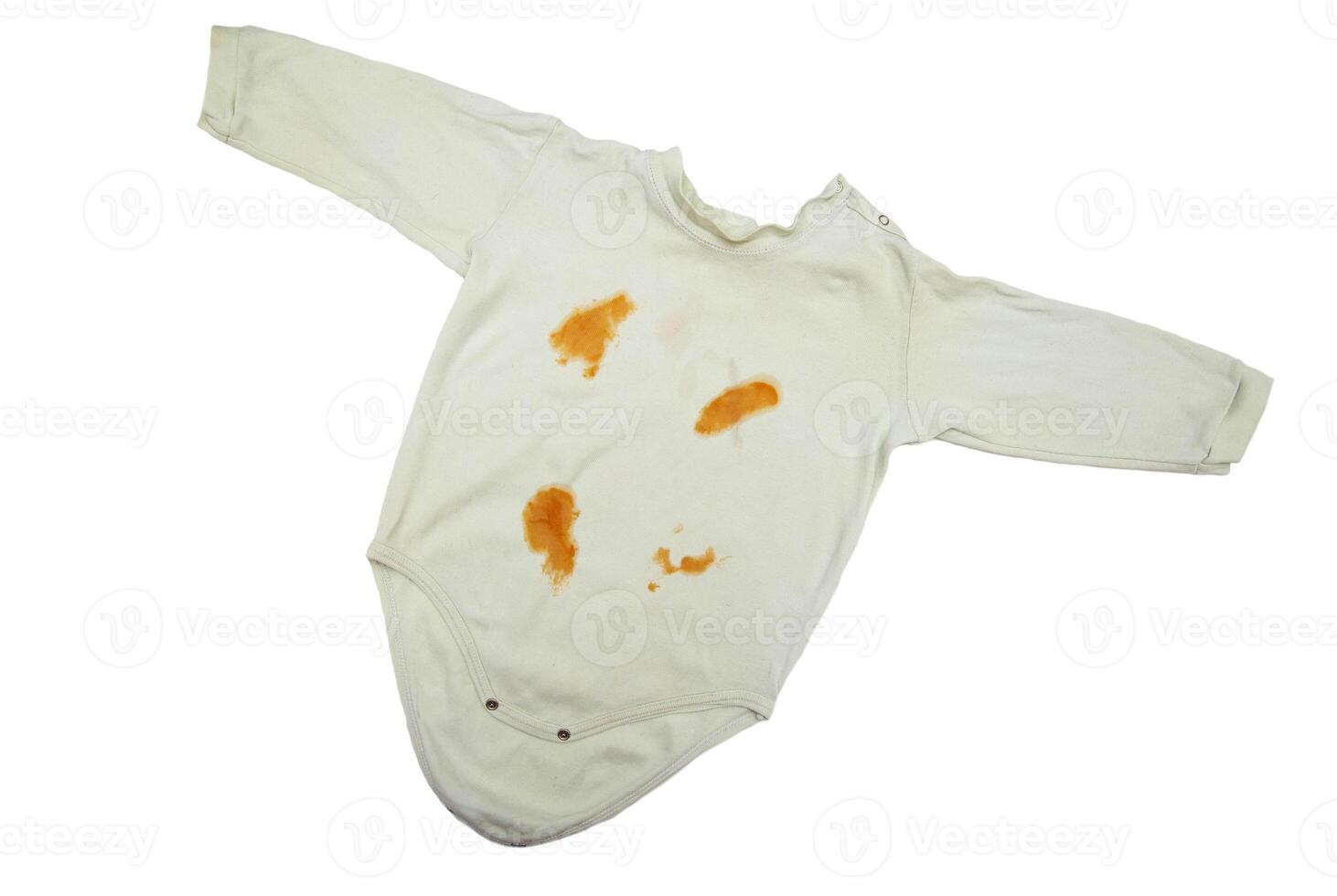 Children's clothing bodysuit with orange stains from vegetable puree on a white background, isolate. Oxygen stain remover concept, close-up photo