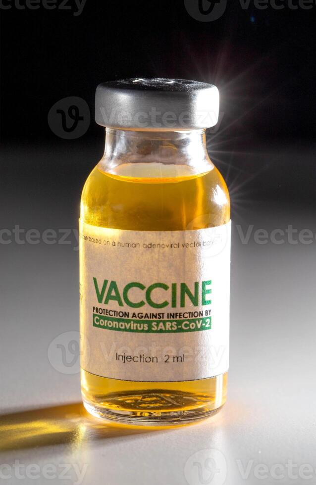 Vial with coronavirus vaccine on a black background, close-up. Vaccine development and research concept SARS-Cov-2 and covid-19 photo