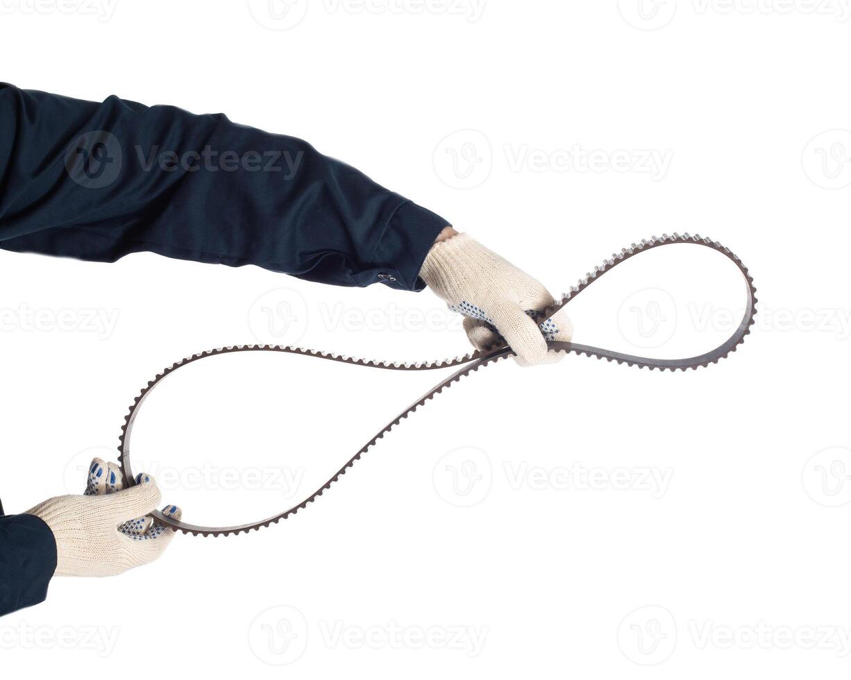 Auto locksmith holding a used timing belt on a white background, isolate. Regulations for replacing belts and rollers of the engine, industrial photo