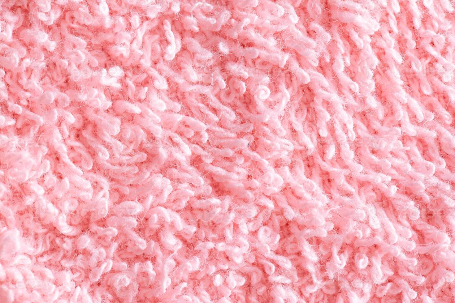 Texture background fabric with pile. Pink soft cloth, macro photo