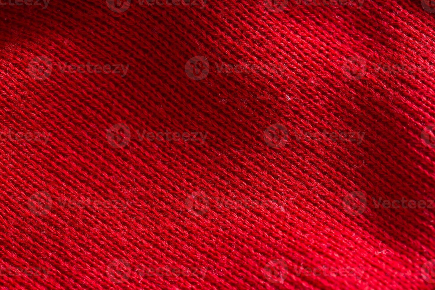 Red knitted sweater close-up. Material background, macro photo