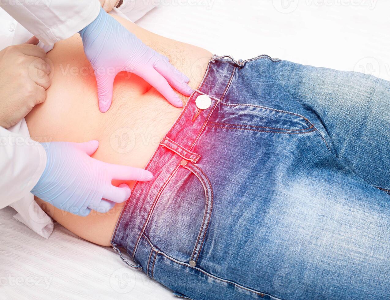 The doctor examines a sick patient who has pain in the right lower abdomen. Concept of inflammation of appendicitis, peritonitis. Removal of appendicitis in surgery photo