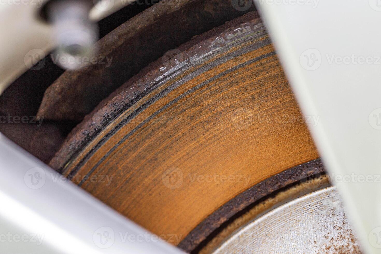 Rusty, defective brake disc with a shoulder on the edge. Worn brake disc concept, brake failure, macro photo