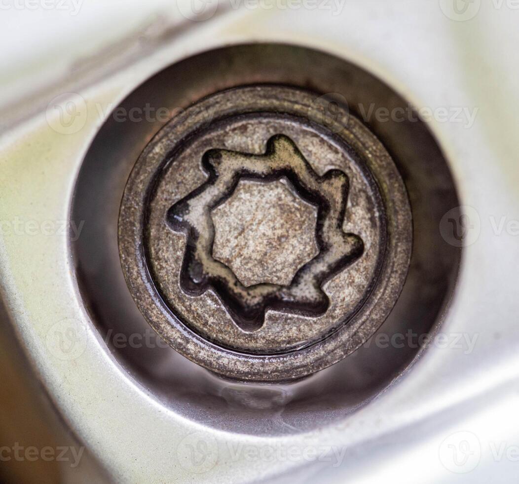 A secret bolt in a car wheel. Anti-theft protection, macro photo
