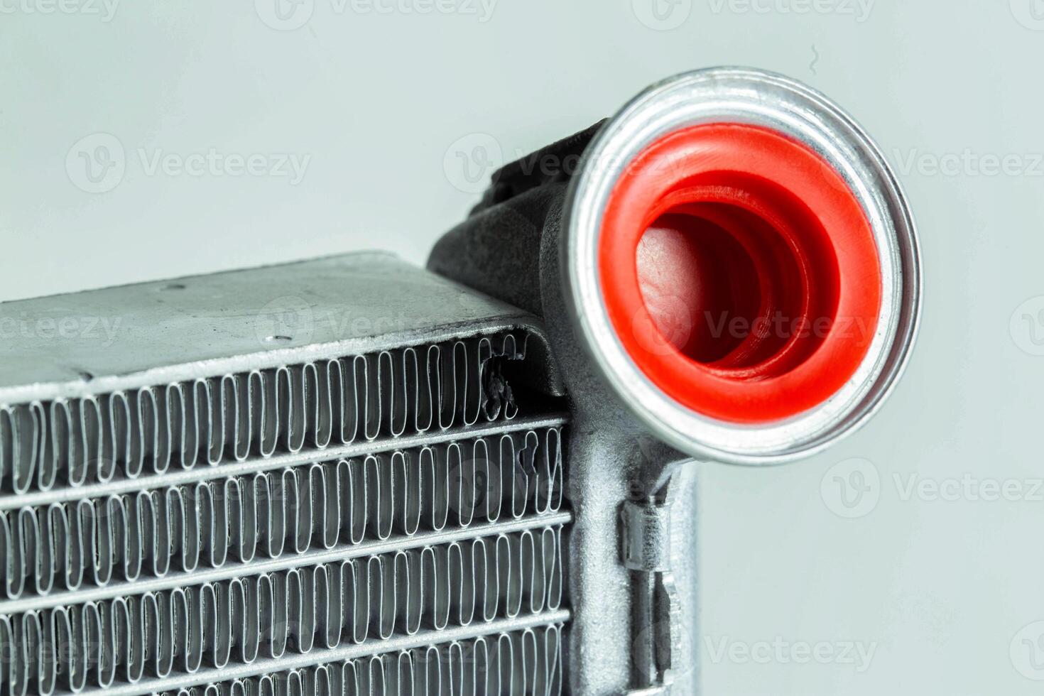 Part of a car heater radiator on a white background, close-up. Automotive spare part. Close-up photo