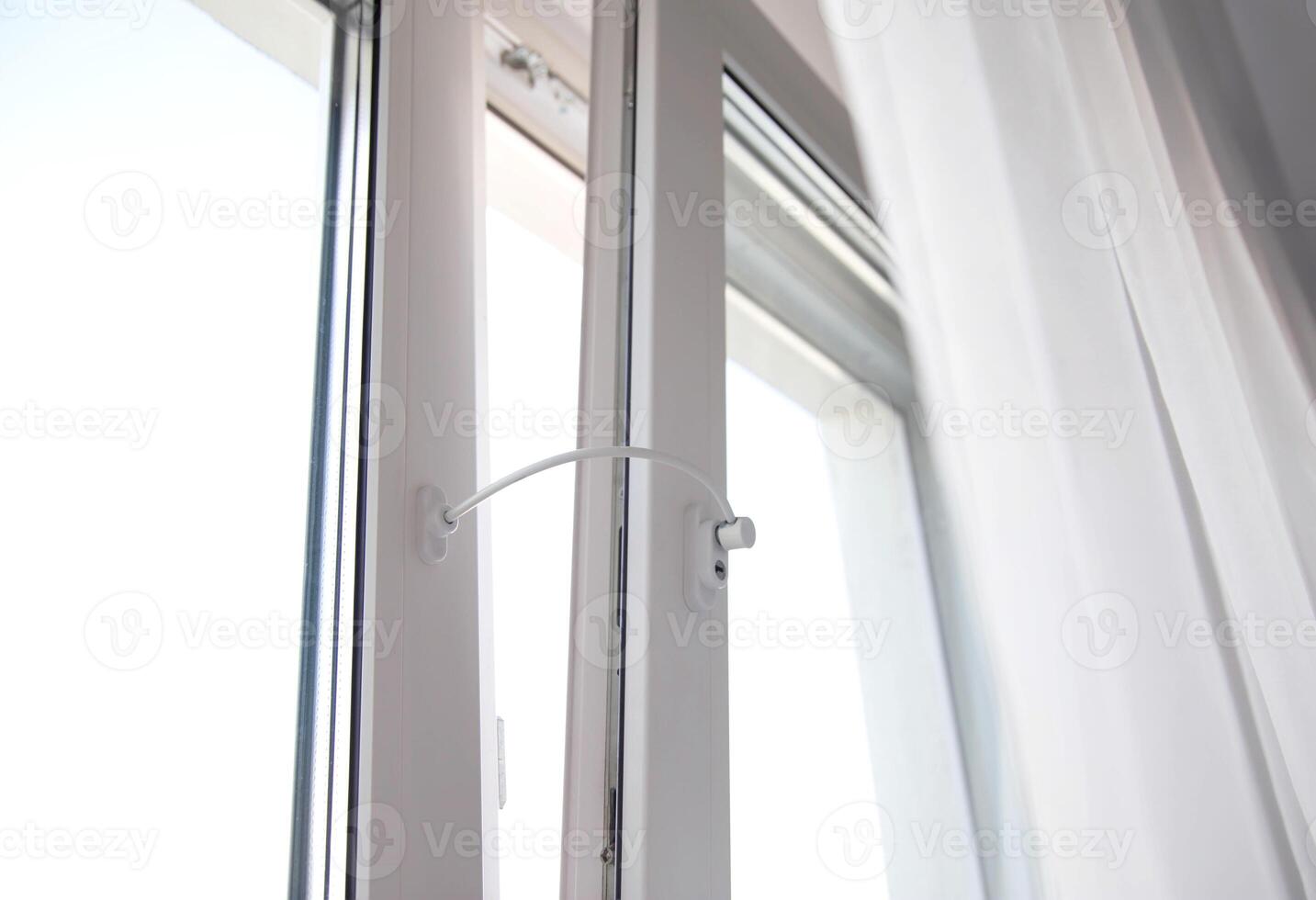 Child lock on the windows of the house, blocking device for opening windows by children. Falling from the window photo