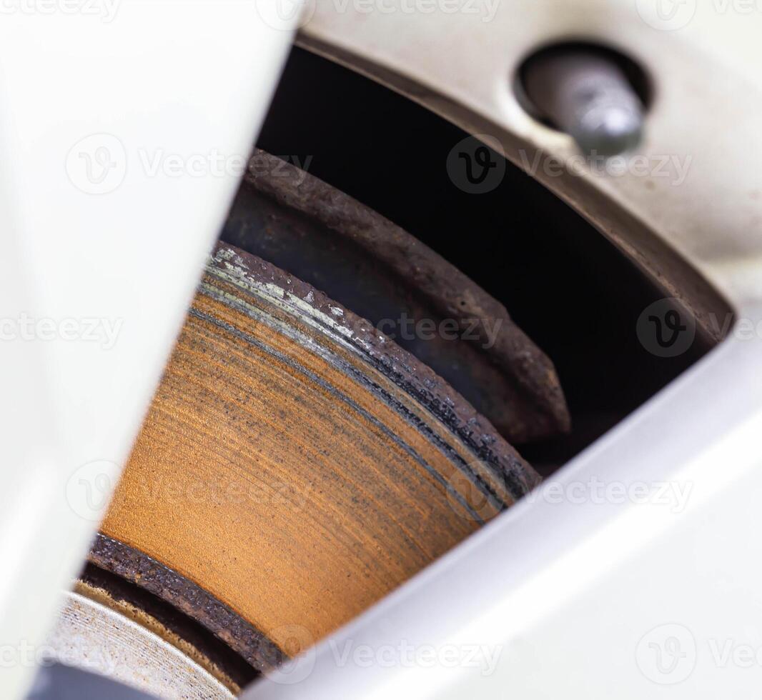 Rusty, defective brake disc with a shoulder on the edge. Worn brake disc concept, brake failure, macro photo