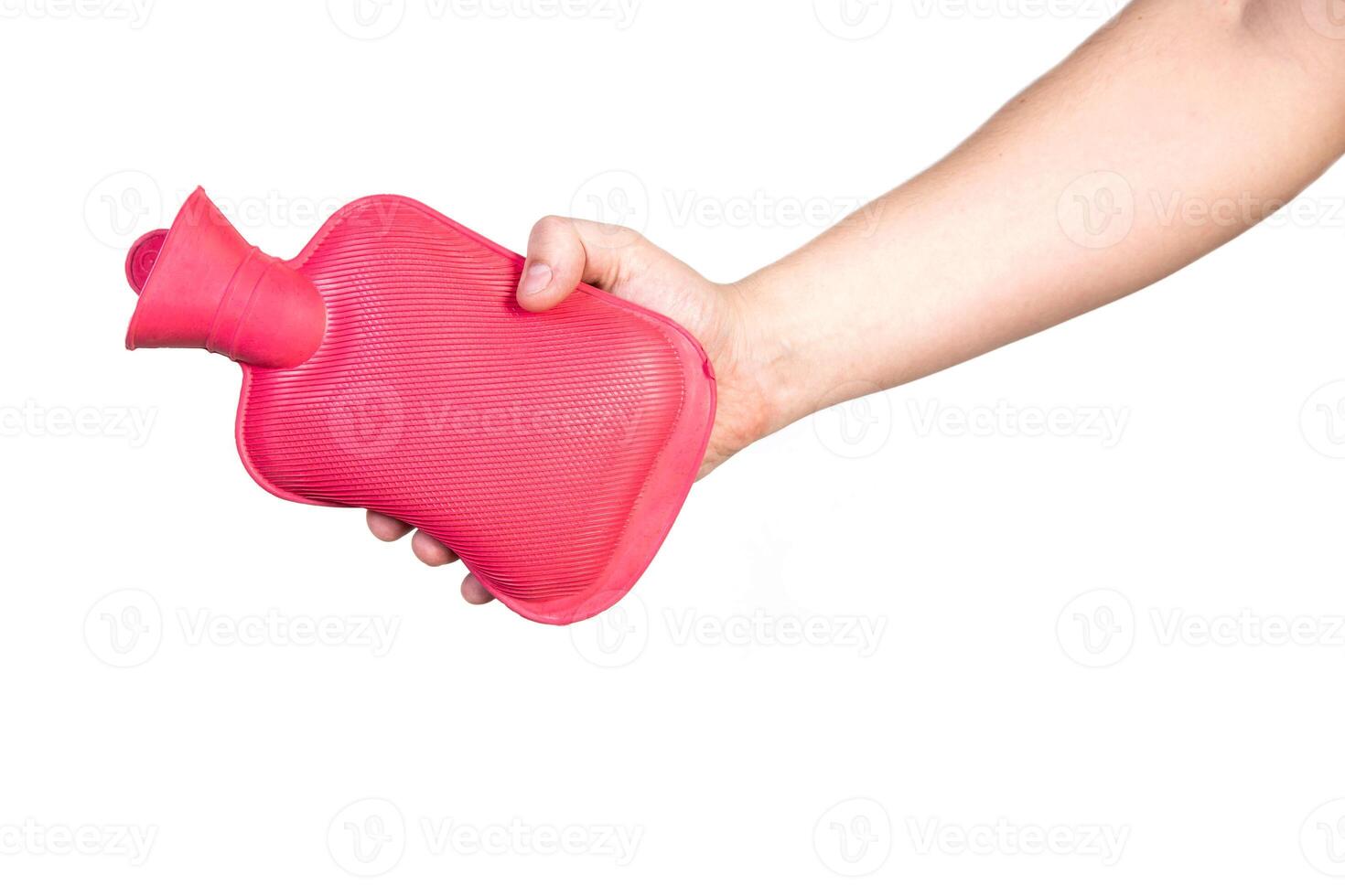 Red medical heating pad with hot water in hand on a white background, isolate. Heat treatment, heat therapy. Close-up photo