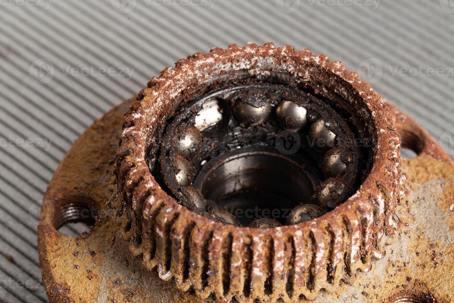 Old rusty wheel hub with a broken bearing. Bearing jamming. Automotive Part, close-up. photo