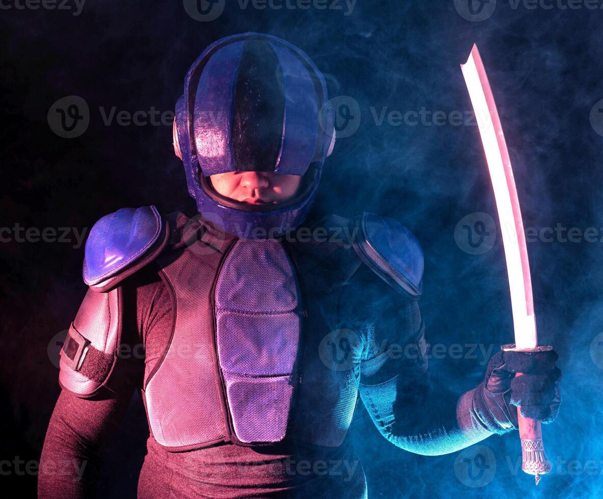Cyberpunk future concept. Bionic cyborg police officer with short samurai sword stands in dark with smoke, fume. Halfman robot looks at camera. Futuristic science fiction scene. photo