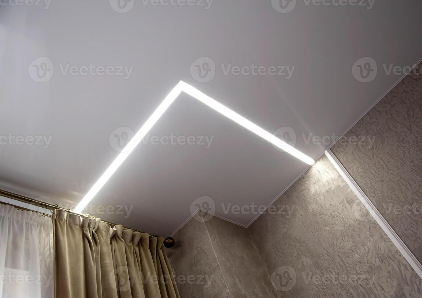 Diode lighting in the corners of the ceiling in an apartment with a stretch ceiling. Modern design, close-up photo