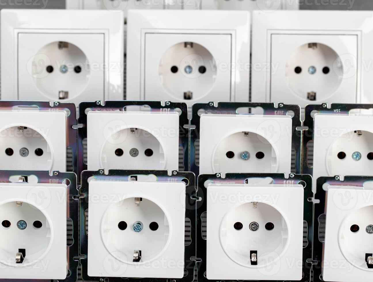 Many modern electrical sockets on a gray background, close-up. Rise in the price of electricity price per kilowatt, saving electricity, close-up photo