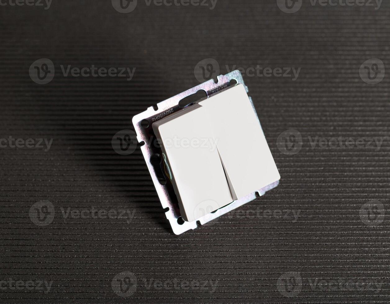 Modern two-gang switch on a gray background, close-up. Electric photo