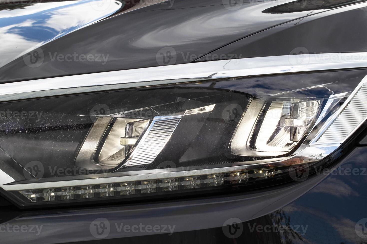 Economical and modern car headlight with LED adaptive light. Close-up, illuminate photo