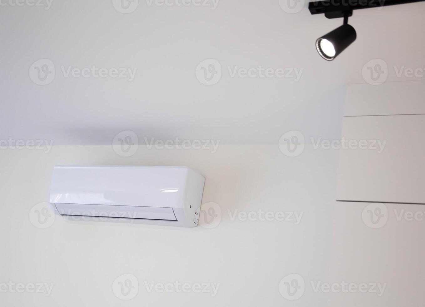 Modern wall-mounted air conditioner in the apartment with heating and cooling capacity of the room. Comfortable temperature. Copy space for text photo