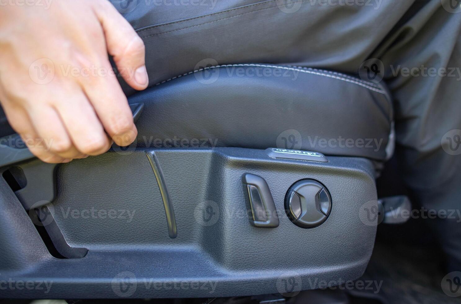 Mechanical adjustment of the height of the driver's seat in the car, close-up photo