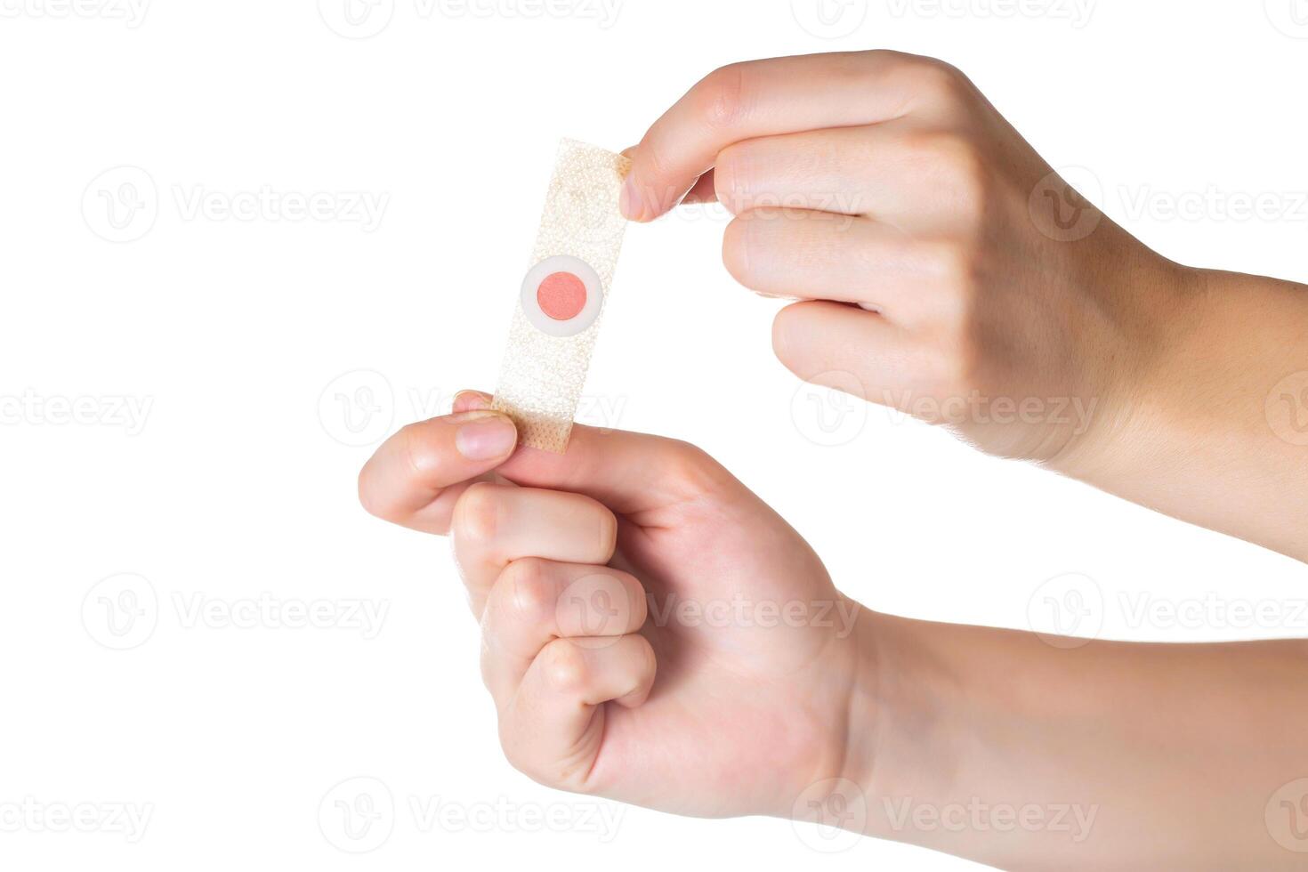 The girl holds in her hands a plaster against core calluses on her legs. White background, isolate, close-up photo