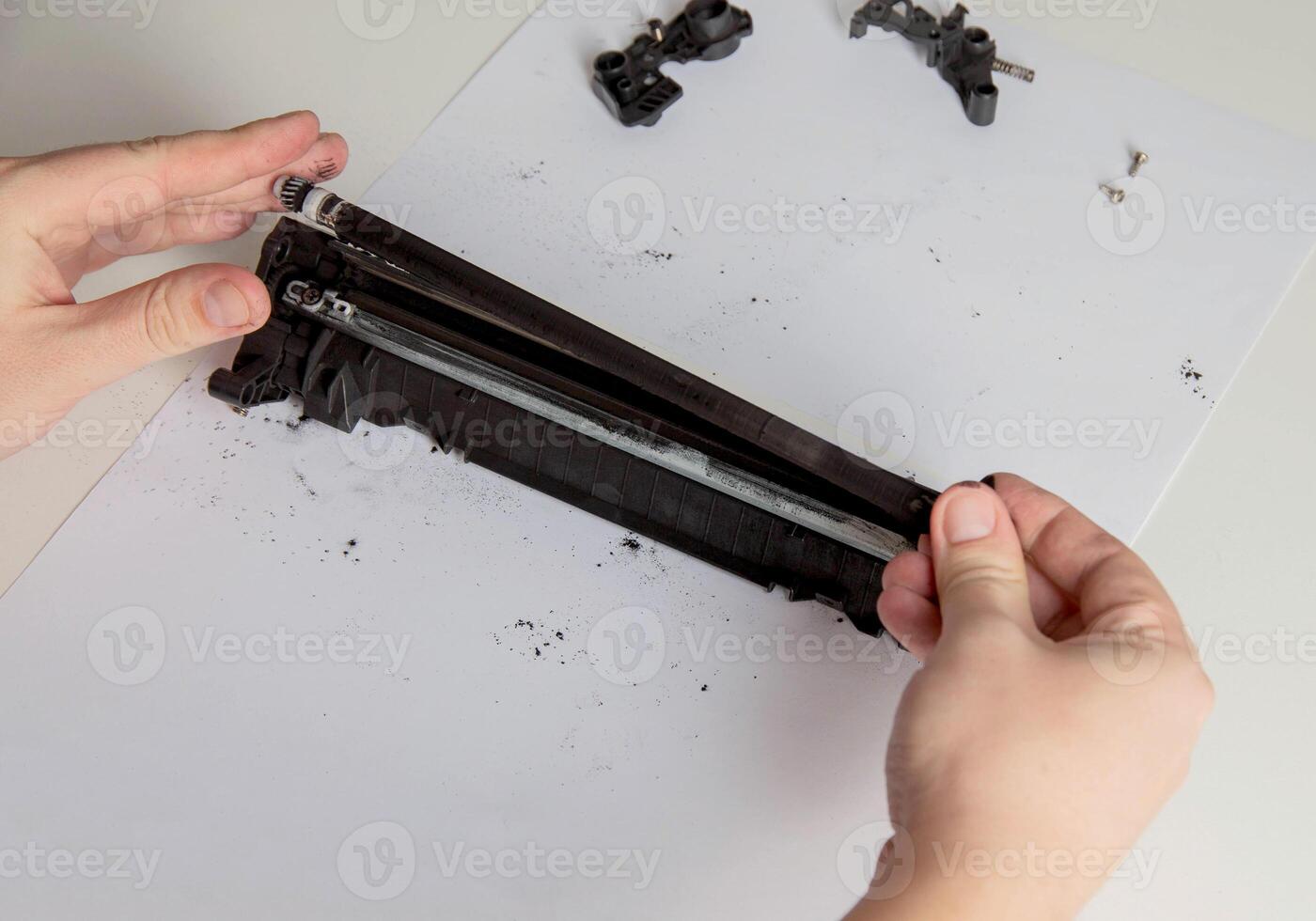 Disassembly of a drum cartridge on a white background. Cleaning and maintaining cartridge parts. Copy space for text photo
