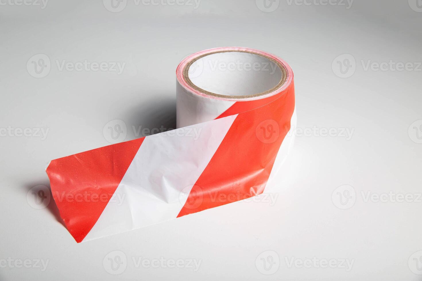 Red-white striped ribbon on a white background, isolate. Prohibition tape, close-up photo