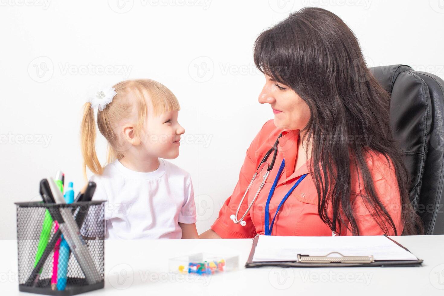 Little caucasian girl 3-4 years old at the appointment with a pediatrician. Varieties of children's doctors, children's medicine photo
