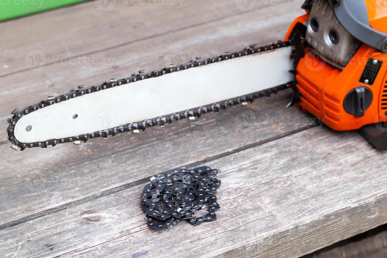 New chain for chainsaw. Setting up and replacing the chain on the chainsaw from the old to the new. Chain sharpening. Industry photo