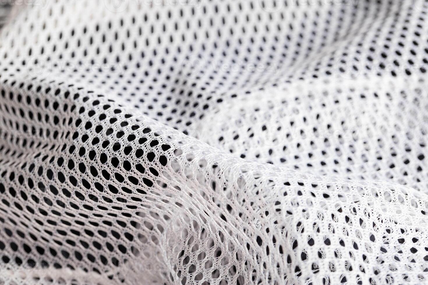 White lining in clothes in a hole, macro. Textured photo