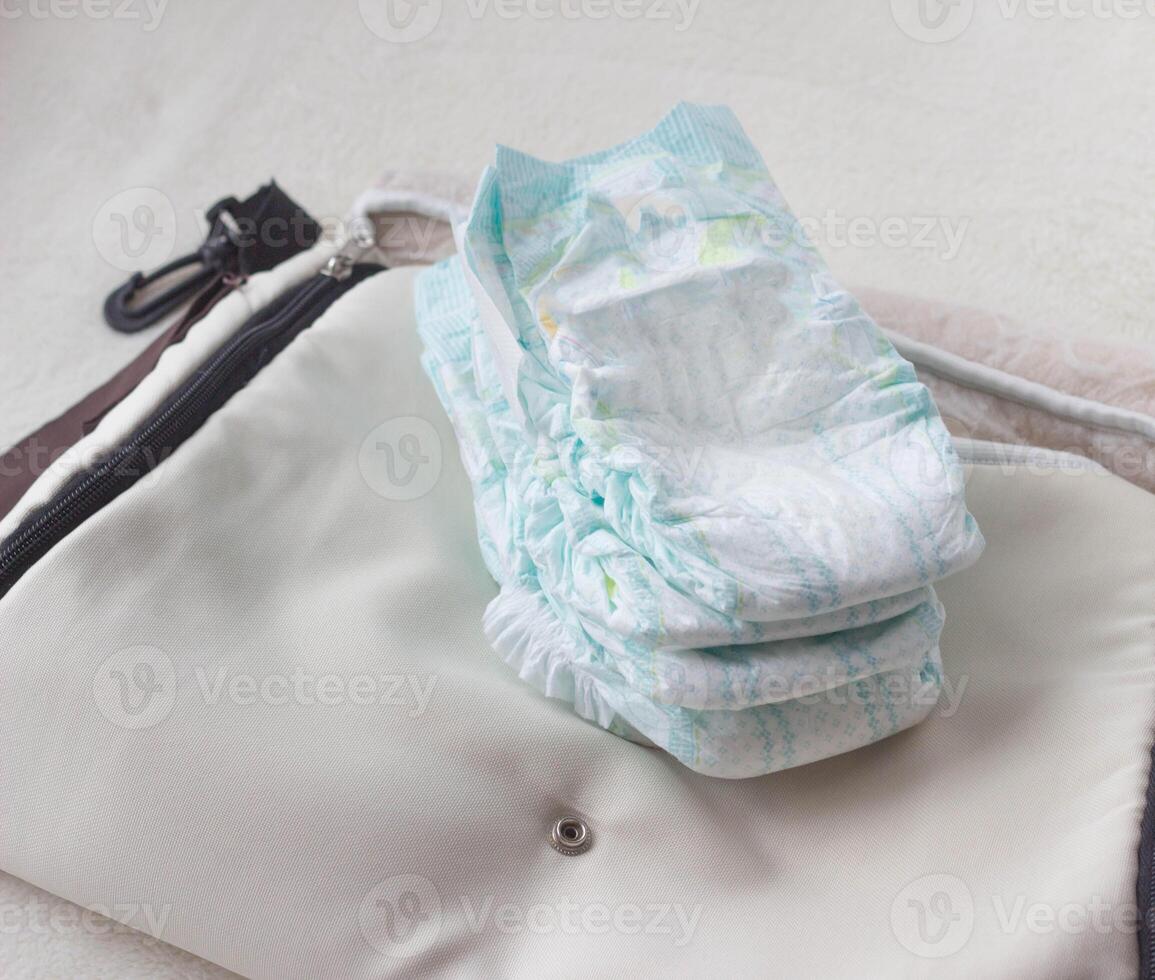 Baby diapers lie on the bag, diapers with you on the road photo