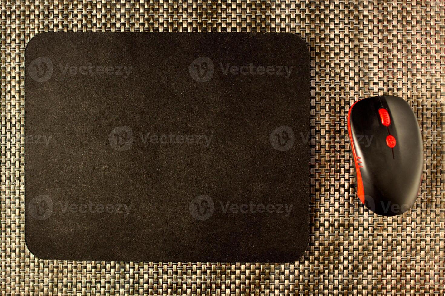 Computer mat and computer mouse on wicker texture wipes, close-up photo
