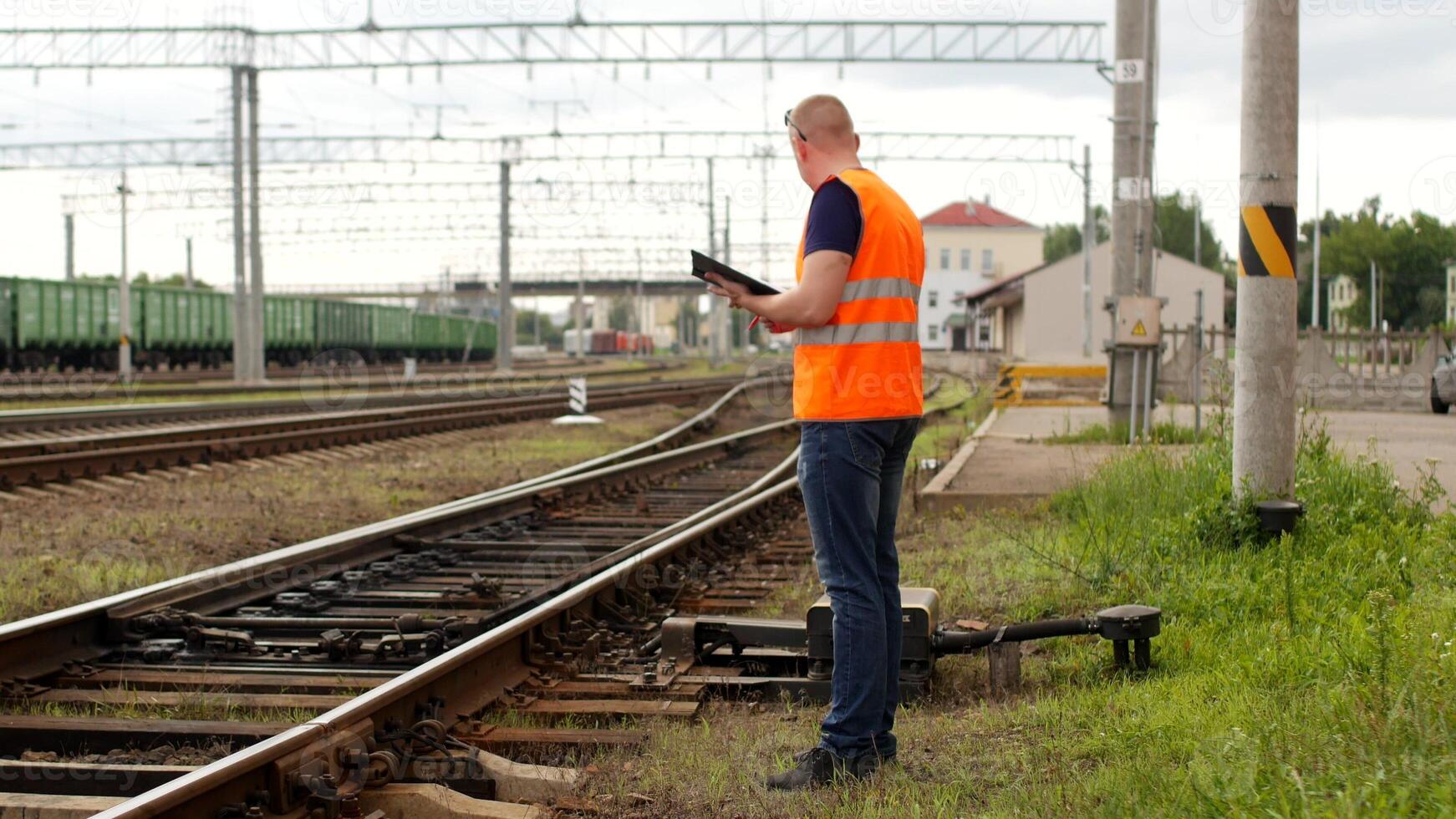 Inspector inspects checks the automatic switch mechanism on the railway, railway switch mechanism and inspector photo